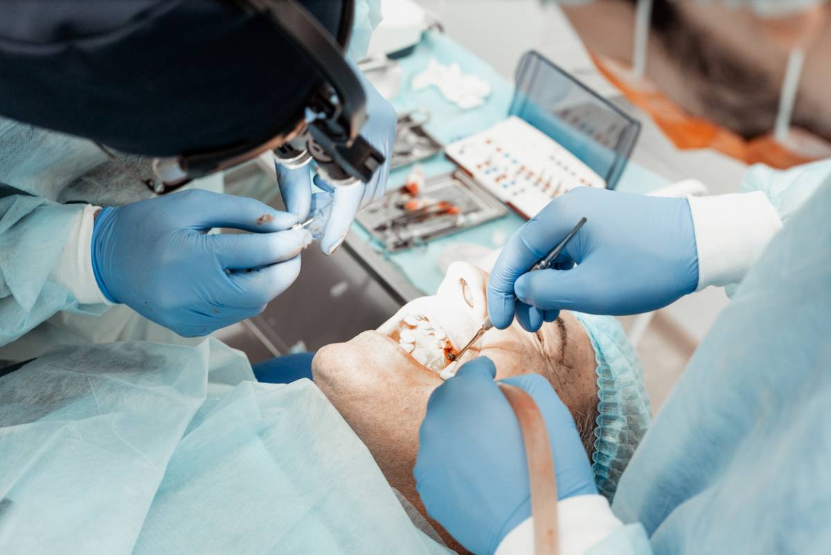 Dentists performing procedure.