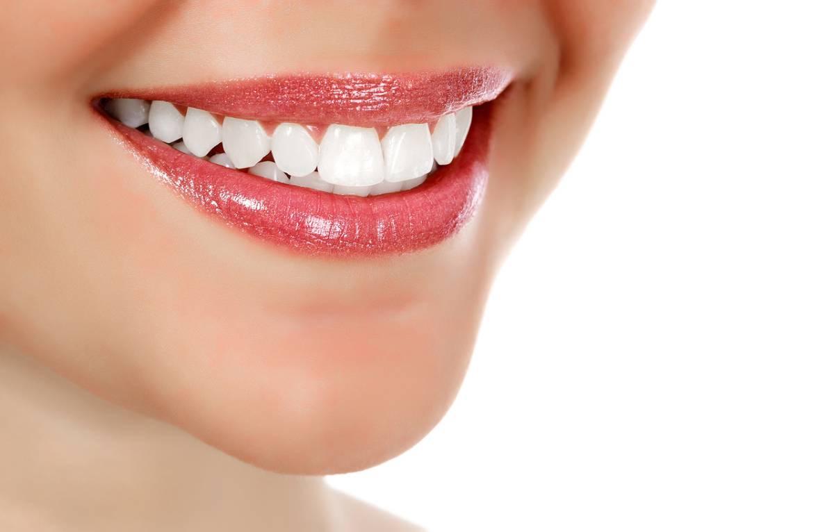 Woman with a bright smile who knew how to improve teeth whitening results.